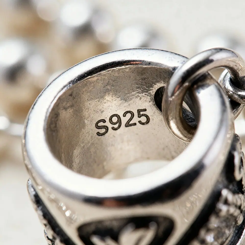 Close-up of S925 sterling silver hallmark on an authentic Gnoce charm